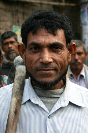 Day laborer waiting at Towne Hall Bazaar for someone to hire him for digging.