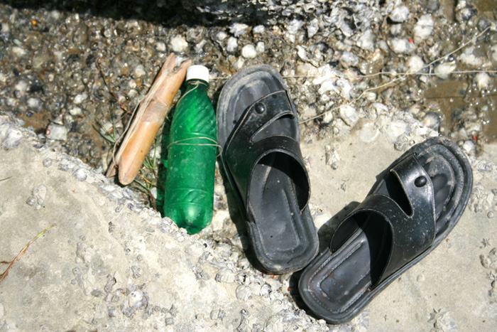 Under the Pier Moheshkhali Fisherman stepped out of his sandals to fish.