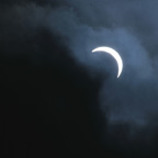 Solar Eclipse dancing in and out of the clouds.