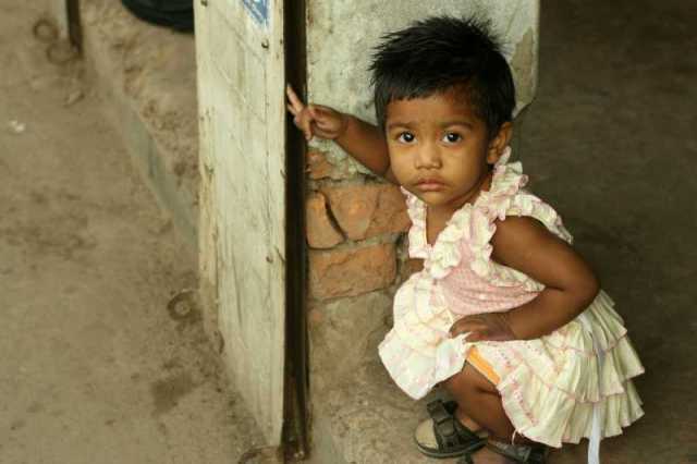 Gazing at the camera with wonder.