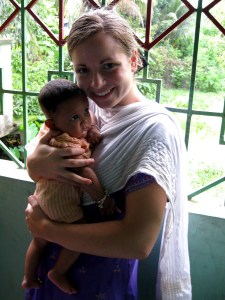 Kasey with little child in village.