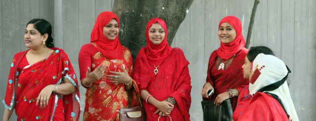 Mothers gathered on the sidewalk waiting for their children to finish school!