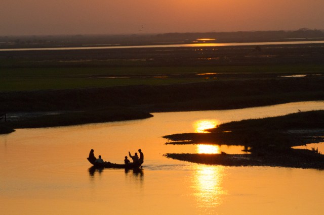 Boat Ferrying Family Across the River at Sunset!